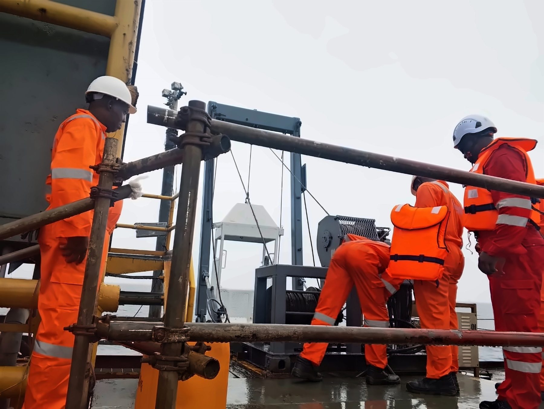 Dive Marine crew operating deck equipment